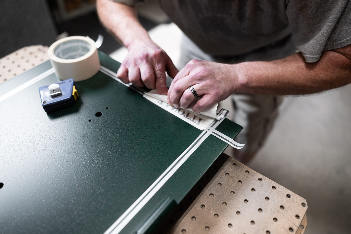 Tape measure across a green safe panel